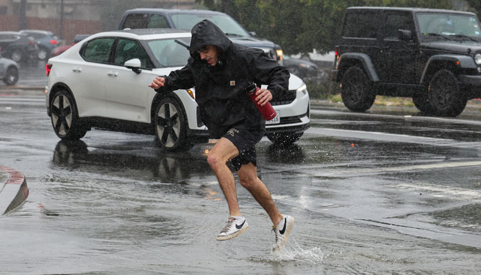 A pedestrian is seen drenched during heavy rain in San Diego, California, US January 22, 2024. — Reuters