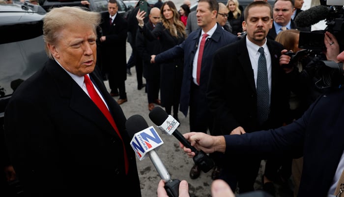 Republican presidential candidate, former US President Donald Trump talks to reporters while visiting the polling site at Londonderry High School on January 23, 2024, in Londonderry, New Hampshire. — AFP