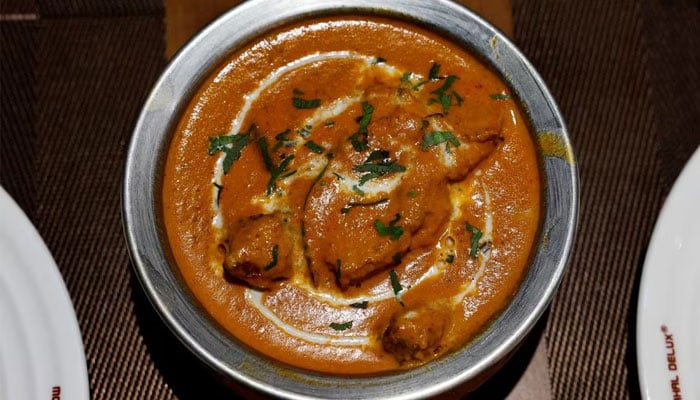 A freshly prepared butter chicken dish is placed on a table inside the Moti Mahal Delux restaurant in New Delhi, India, January 23, 2024. — Reuters