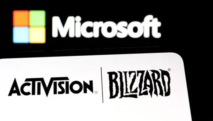 Microsoft logo is seen on a smartphone placed on displayed Activision Blizzard logo in this illustration taken January 18, 2022. —Reuters