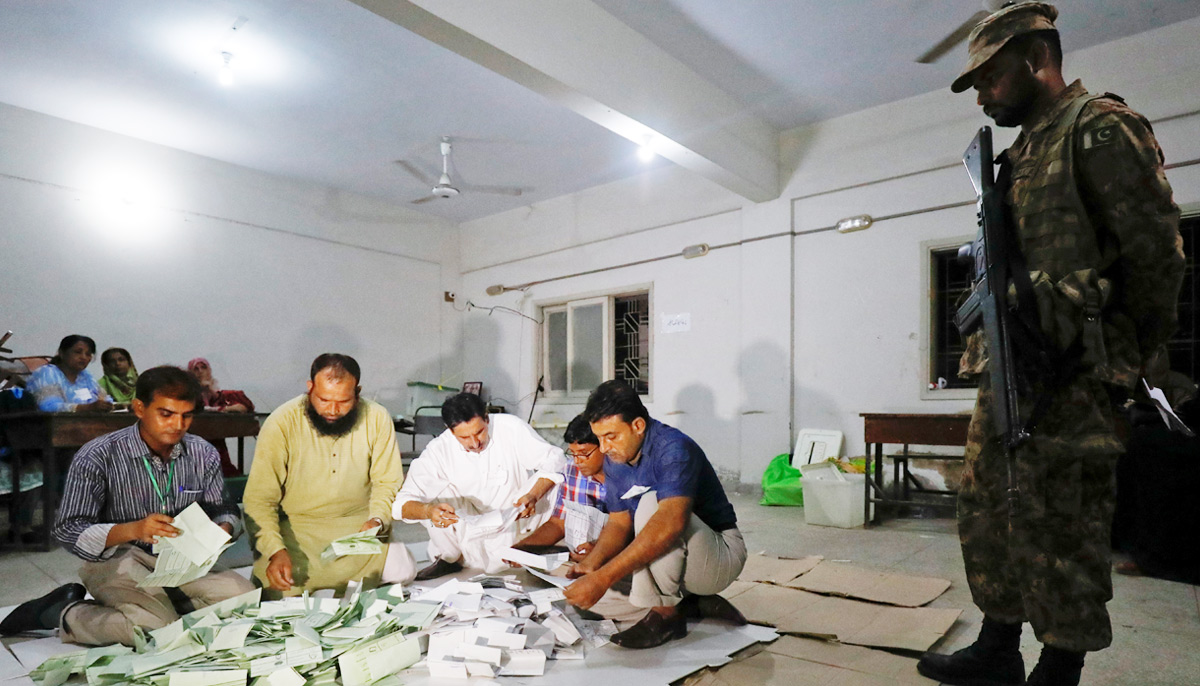 Election officials count votes after polling stations closed during the general election in Karachi, Pakistan, July 25, 2018. — Reuters