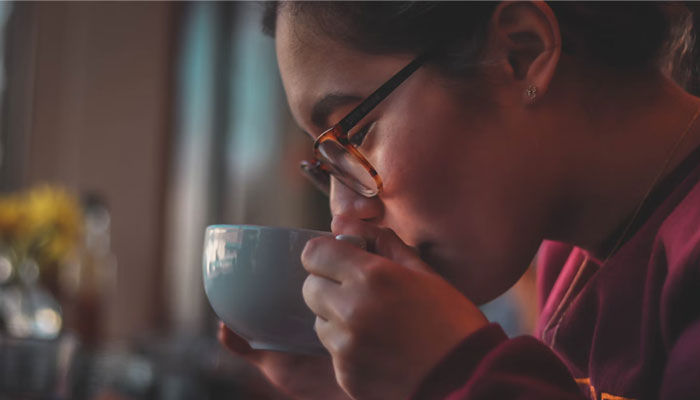 Representational image of a woman drinking tea. — Unsplash