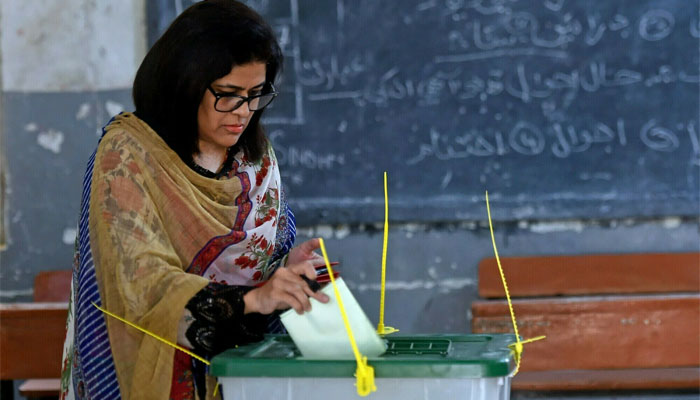 A female voter casts her ballot at a polling station during the by-election for National Assembly seats, in Karachi. — AFP/File