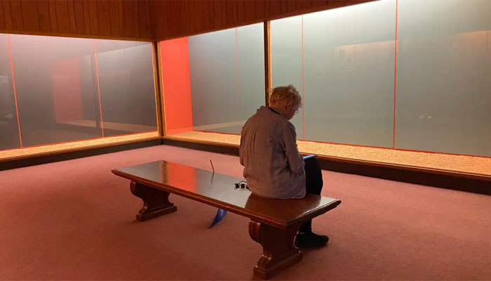 A museumgoer sits on a bench in front of covered displays on January 26, 2024. — The New York Times via Redux
