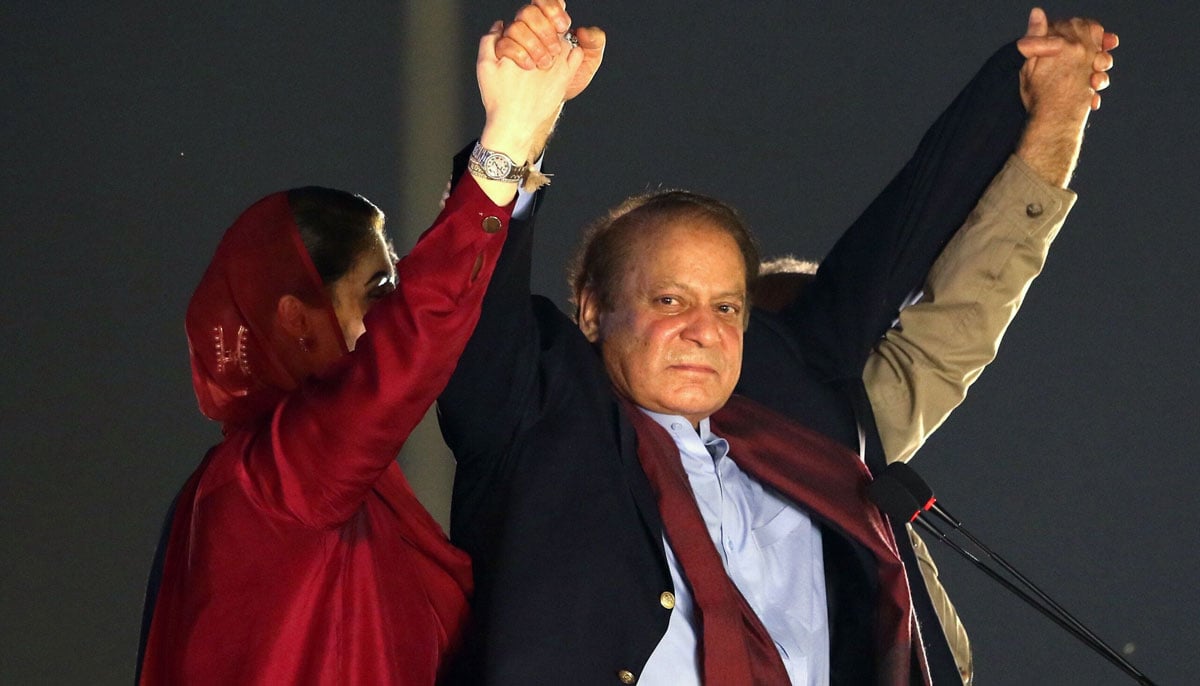 Nawaz Sharif raising hands of daughter Maryam Nawaz and brother Shehbaz Sharif in a public gathering in Lahore in 2023.—Reuters