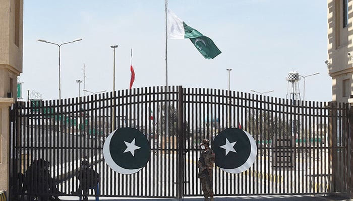 Pakistani soldiers wearing facemasks stand guard at the closed Pakistan-Iran border in Taftan on February 25, 2020. — AFP