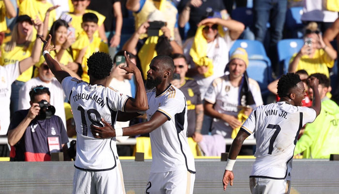 Real Madrids French midfielder Aurelien Tchouameni (L) celebrates scoring the winner against Las Palmas to take his team top of La Liga. — AFP