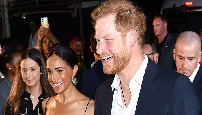 Prince Harry looked anxious as he followed Meghan Markle at Bob Marley premiere