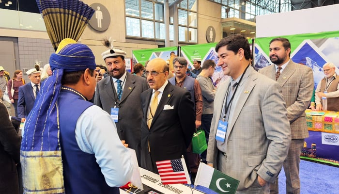 Pakistan’s Ambassador to the United States Ambassador Masood Khan (centre) at the Pakistan Pavilion during the travel show in NY, US. — Supplied