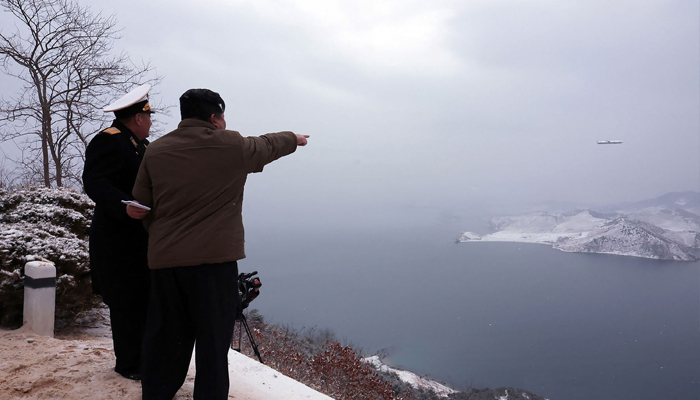 This picture taken on January 28, 2024, shows North Korean leader Kim Jong Un (R) inspecting a test-fire of the submarine-launched strategic cruise missile Pulhwasal-3-31 at an undisclosed location in North Korea. — AFP