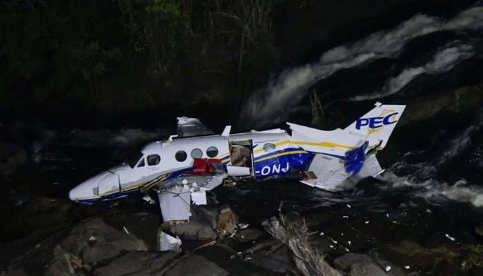 The wreckage of a small airplane that crashed is seen near a waterfall area in Piedade de Caratinga, state of Minas Gerais, Brazil. — Reuters/File