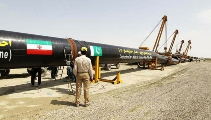 Iranians work on a section of a pipeline linking Iran and Pakistan after the project was launched during a ceremony in the Iranian border city of Chah Bahar on March 11, 2013. — AFP/File