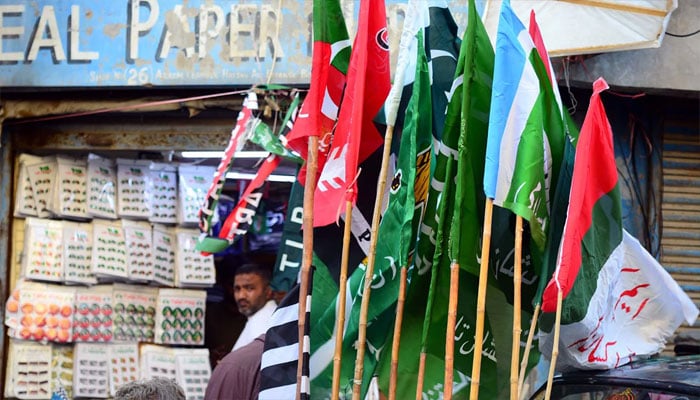 Different political parties caps, T-shirts, badges, and flags are being sold in Karachi on January 16, 2024. — PPI