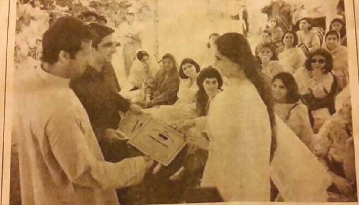 Imran Ismail and Imran Khan distribute certificates to party workers for outstanding work in 1997.— Agencies