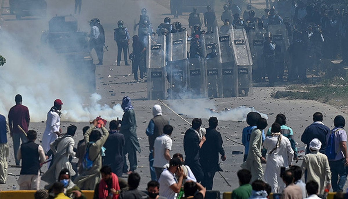 In this photo, taken on May 10, 2023, supporters of Imran Khan clash with policemen during a protest against the arrest of their leader, in Islamabad. —AFP