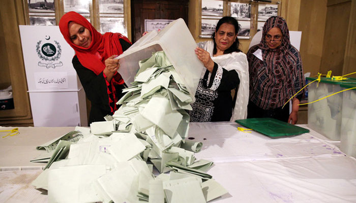 Election officials transfer votes for manual counting. — Reuters/File