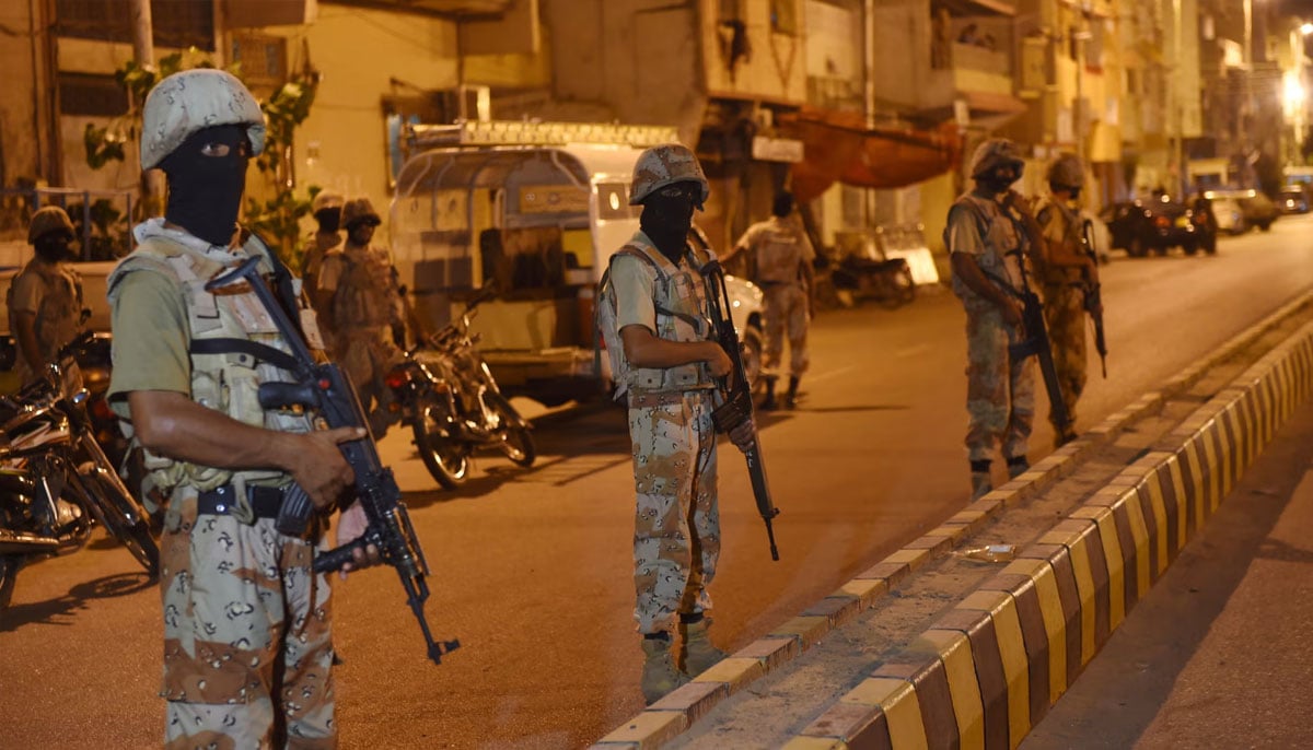 Paramilitary forces cordon off a street leading to the MQM headquarters in Karachi. —AFP/File
