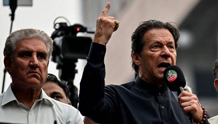 PTI leaders Shah Mahmood Qureshi and Imran Khan addressing a party rally in this undated picture. — AFP/File