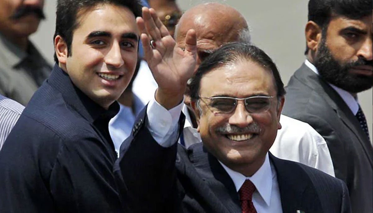 Former President of Pakistan Asif Ali Zardari waves at public as a young Bilawal Bhutto-Zardari looks on.— PTI