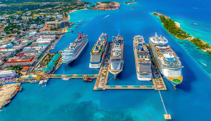 This image shows an aerial view of giant cruise lines docked in the Bahamas. — Unsplash