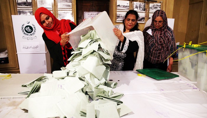 Election officials count ballots after polls closed during the general election in Islamabad, Pakistan, on July 25, 2018. — Reuters