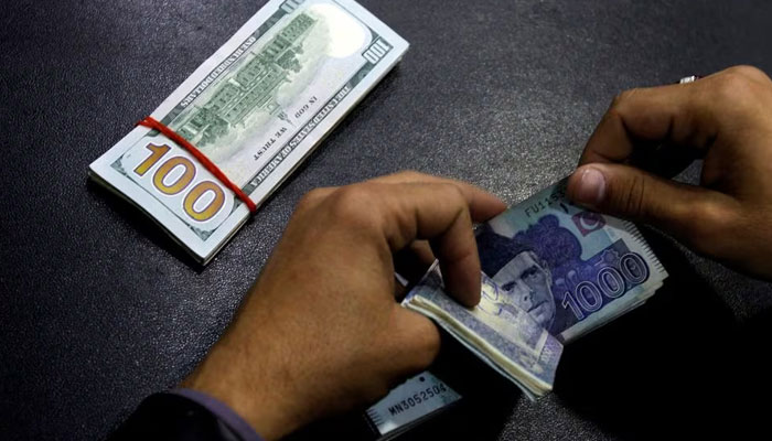 A currency trader counts Pakistani Rupee notes as he prepares an exchange of U.S dollars in Islamabad, Pakistan December 11, 2017. — Reuters