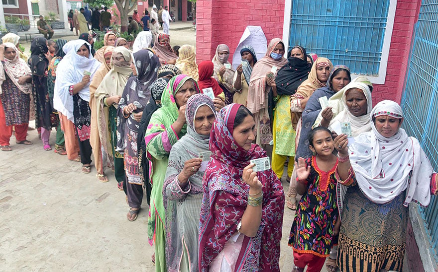 Women stand in queue to cast their votes outside a female polling station during a by-election in Faisalabad. — Online/File