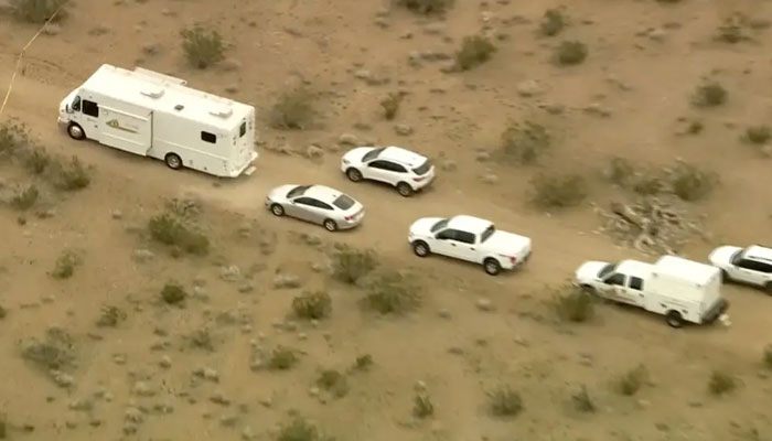 A still image from a video showing law enforcement vehicles where several people were found fatally shot near El Mirage, California. — The New York Times via KTLA