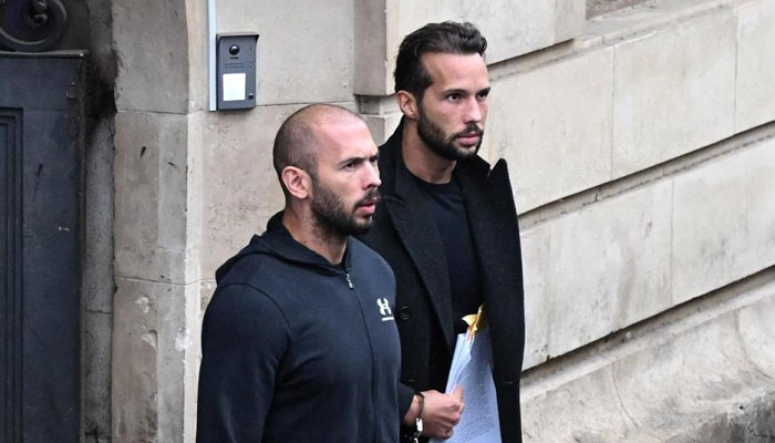 Andrew Tate and his brother Tristan Tate exiting a court in Bucharest, Romania. — AFP/File