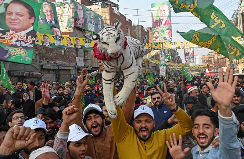 Supporters of former prime minister Nawaz Sharif, chant slogans as they attend an election campaign rally in Lahore on January 29, 2024, ahead of the upcoming general elections. —AFP