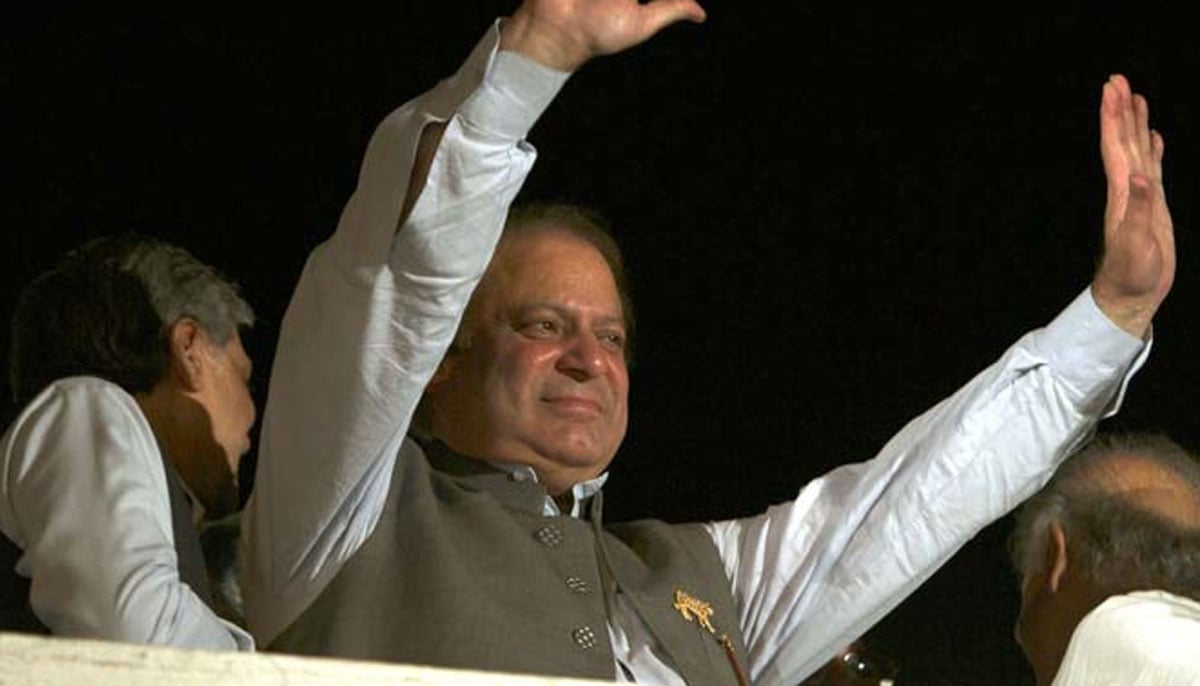 Nawaz Sharif  waves at the public from the roof of his Jati Umra house after victory in 2013 elections on May 11, 2013.—AFP