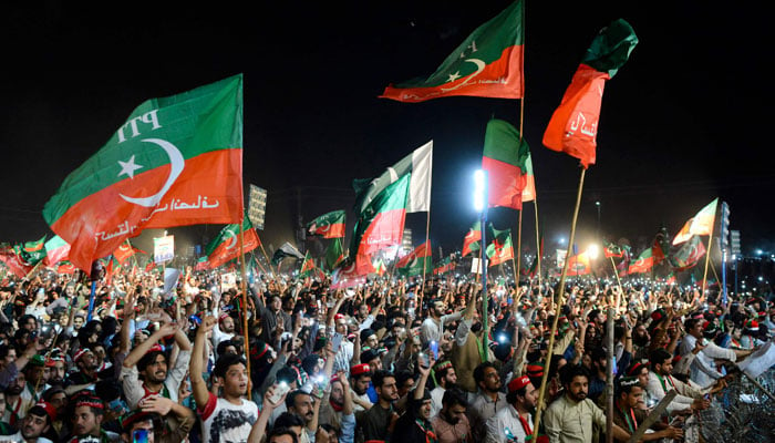 PTI supporters waive their party flags in a public rally in this undated picture. — AFP/File