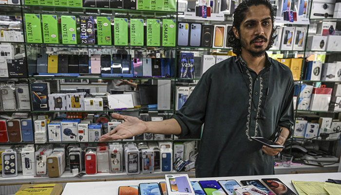 A shopkeeper deals with customers at his mobile shop in Islamabad, Pakistan, on May 20, 2022. — AFP