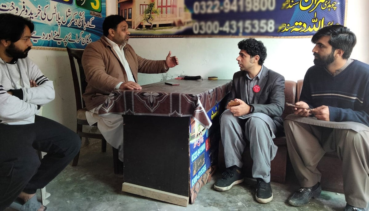 Ammar Ali Jan (second from the right) listens as a local realtor (L) speaks about issues facing PP-160 Lahore, Punjab in this undated photo.—Indtagram@Ammarjan43