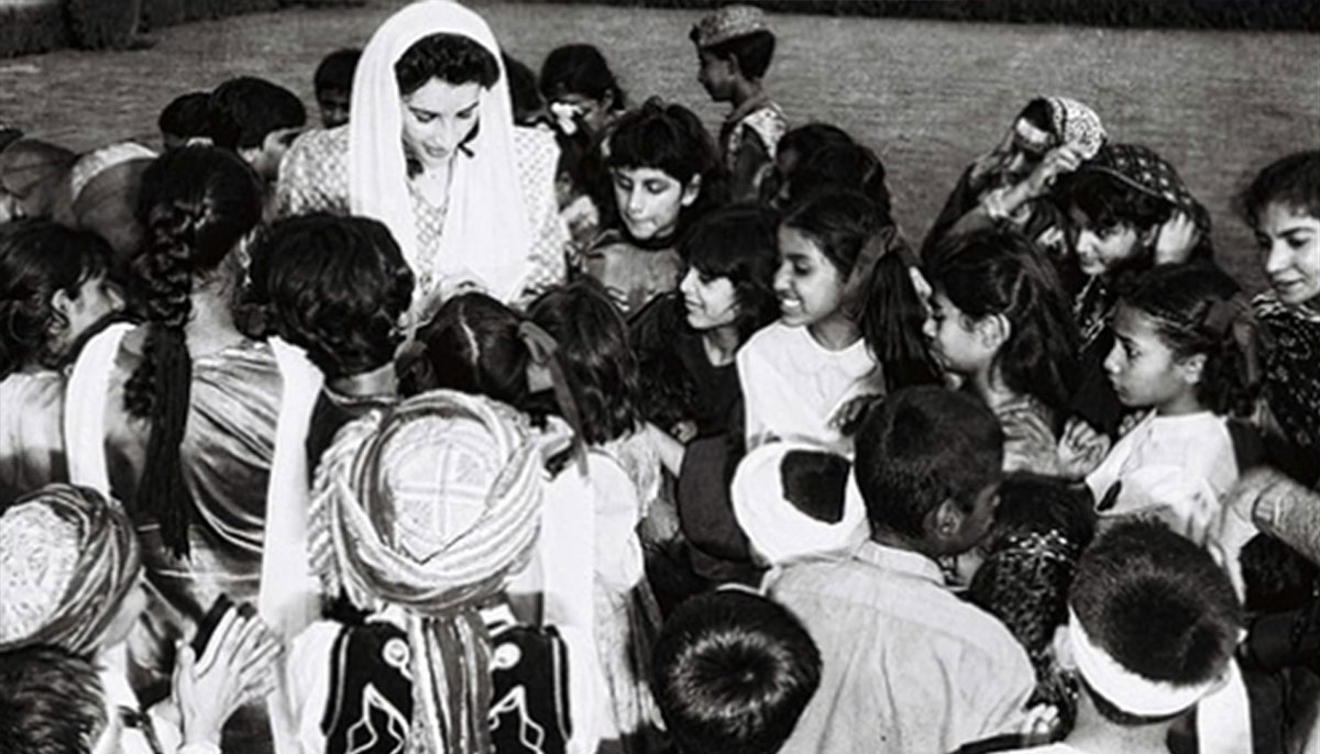 Benazir signs autographs for children in 1994.—Agencies