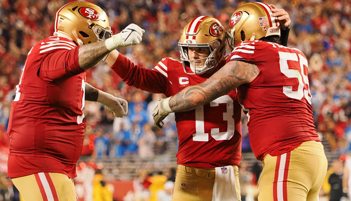 San Francisco 49ers quarterback Brock Purdy (13) celebrates with guard Jon Feliciano (55) and offensive tackle Trent Williams (71) after a play against the Detroit Lions during the NFC Championship football game at Levis Stadium in Santa Clara, California, US on January 28, 2024. — Reuters