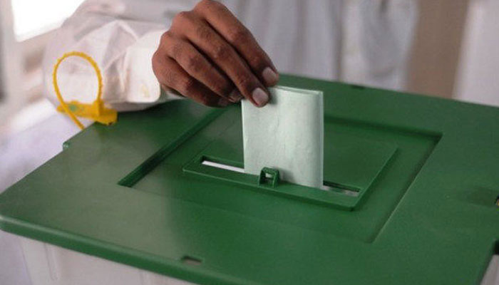 In this undated photo, a voter is dropping a ballot paper in the box during the elections. —AFP