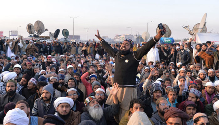 Supporters of the TLP shout slogans during a press conference of their leader Khadim Hussain Rizvi as he announces the end of the sit-in protest on a blocked flyover bridge during a press conference in Islamabad on November 27, 2017. — AFP