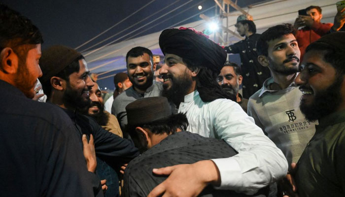 TLP head Saad Rizvi (centre) celebrates with supporters following his release from detention, in Lahore on November 18, 2021. — AFP