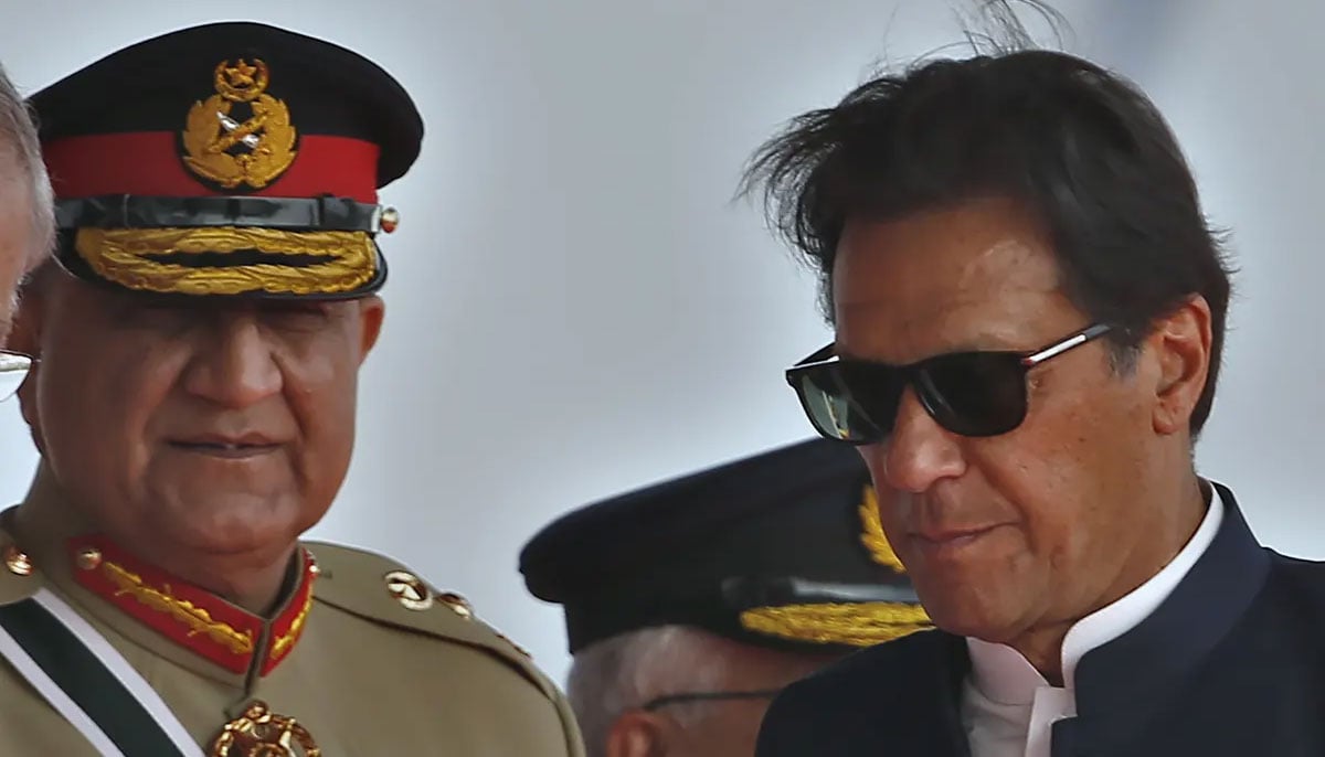 Imran Khan, right, attempted to sack the army chief, Gen Qamar Javed Bajwa, centre, to provoke the military into taking control, said a security official. —AFP