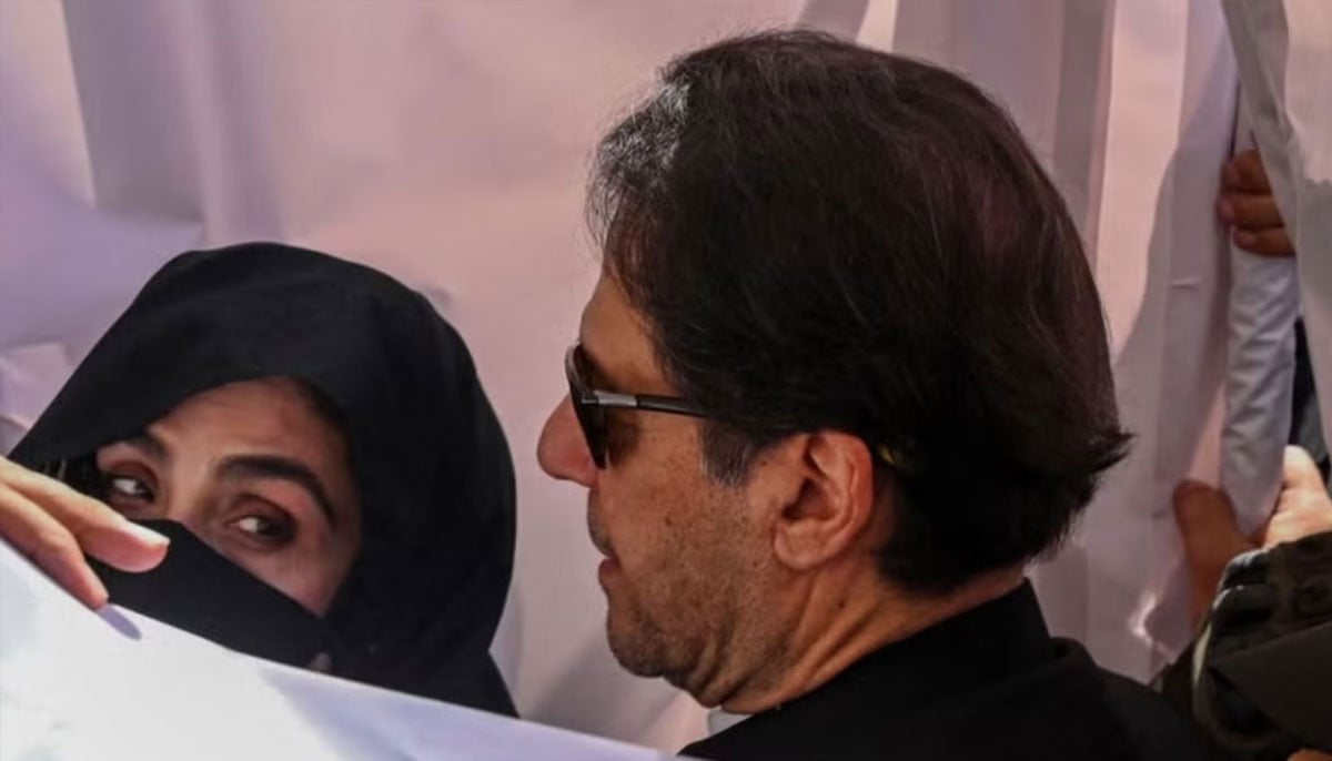 Former prime minister Imran Khan and his wife Bushra Bibi arrive to appear at a high court in Lahore on May 15, 2023. — AFP