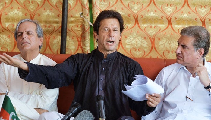 PTI founder Imran Khan (centre), flanked by Shah Mehmood Qureshi (right) and Makhdoom Javed Hashmi (left), speaks during a press conference. — X@PTIofficial