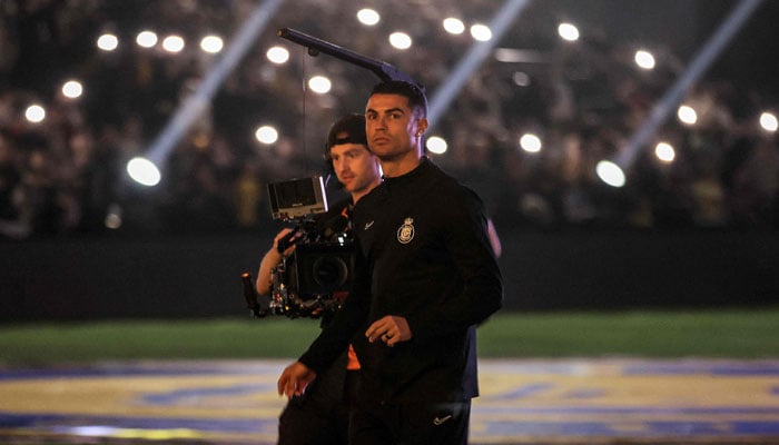 Nassr’s injured Portuguese forward #07 Cristiano Ronaldo is followed by a cameraman on the pitch before the start of the friendly football match between Saudi Arabia’s Al-Nassr FC and the US Inter Miami CF at the Kingdom Arena Stadium in Riyadh on February 1, 2024. — AFP