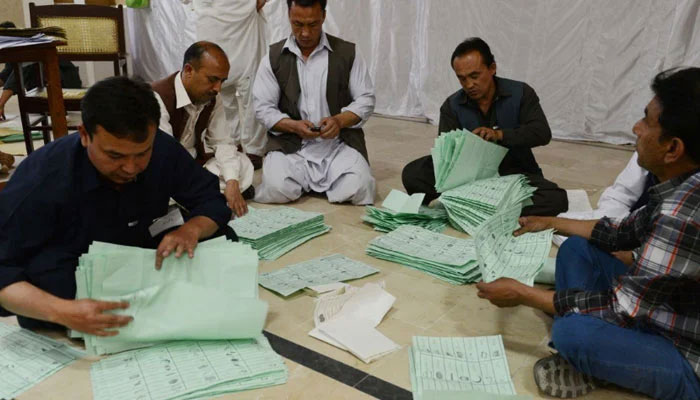 Election officials count ballot papers at the end of polling in Quetta, Pakistan. — AFP/File