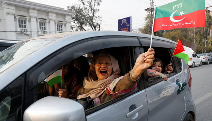 A woman supporter of former Prime Minister Imran Khan waves a flag from a car during a rally ahead of the general elections in Lahore, Pakistan January 28, 2024. — Reuters