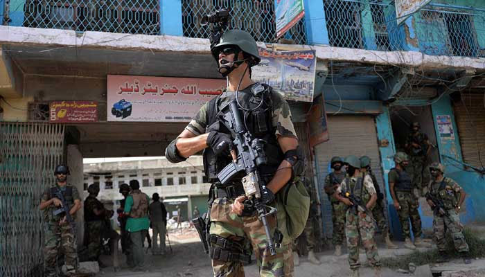 Soldiers patrol at an empty bazaar during a military operation against militants in the main town of Miramshah in North Waziristan on July 9, 2014. — AFP