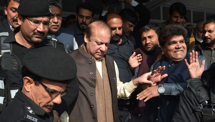 Former Pakistan Prime Minister Nawaz Sharif (centre) leaves the Supreme Court building after the shrine land case hearing in Islamabad on December 4, 2018. — AFP