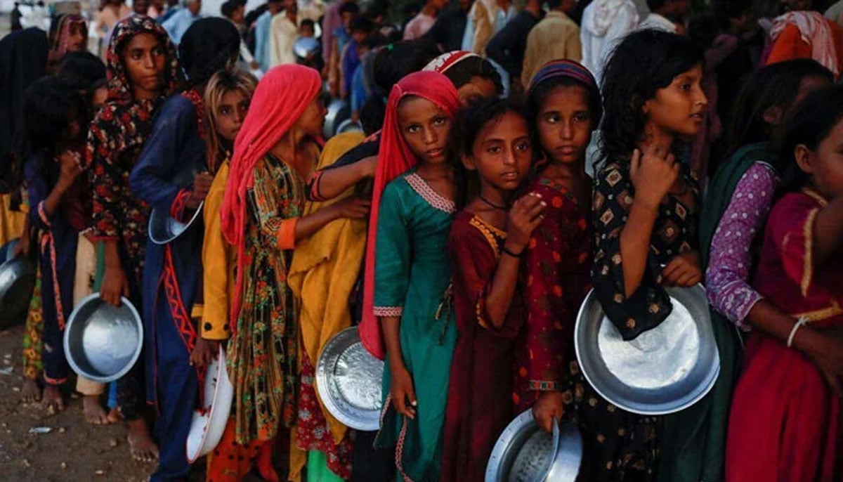 Flood victims gather to receive food handouts in a camp, following rains and floods during the monsoon season in Sehwan, Pakistan September 15, 2022. — Reuters