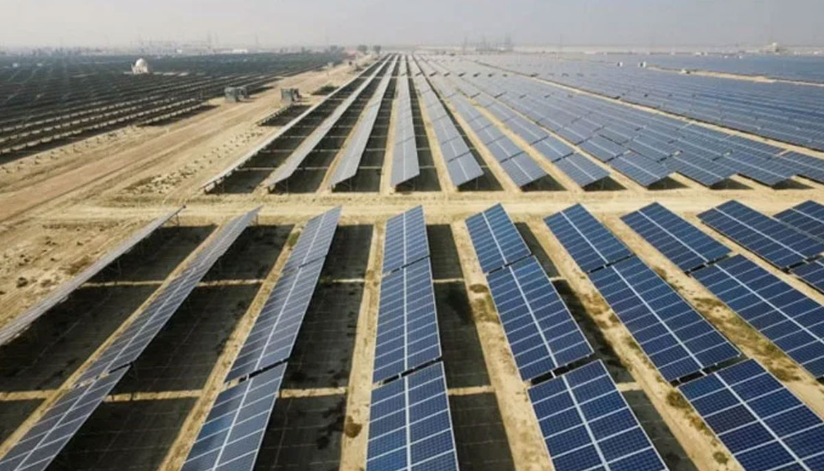 A view of solar panels laid out in a field. — APTMA