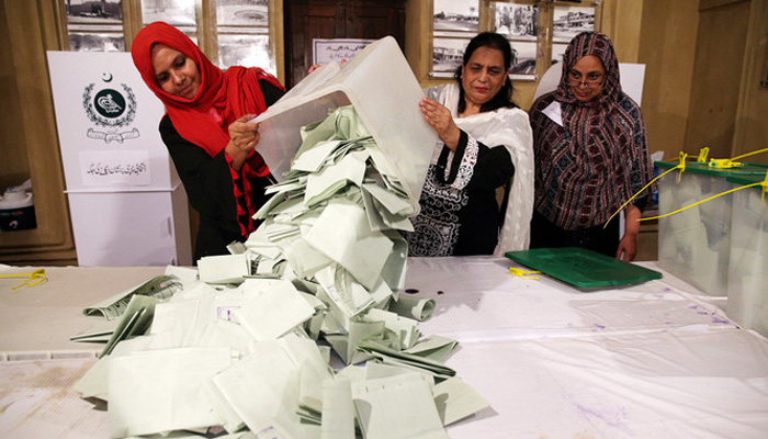 Election officials count ballots after polls closed during the general election in Islamabad, Pakistan, on July 25, 2018. — Reuters